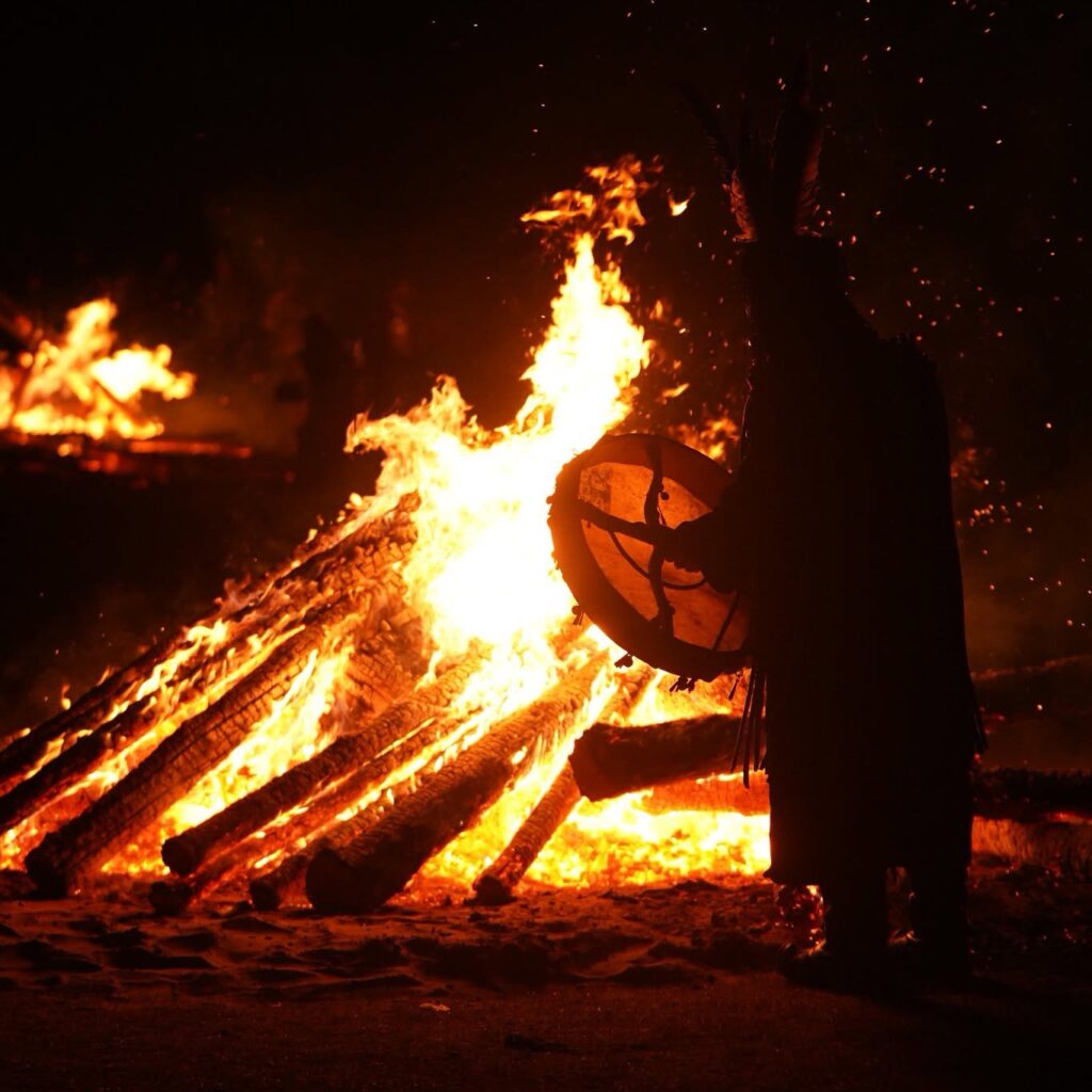 Chamane au tambour devant le feu de cérémonie